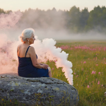 “Woman over 40 relaxing with tea in Atlanta, embracing peace and calm with holistic wellness and cannabis support from Oil & Eve.”