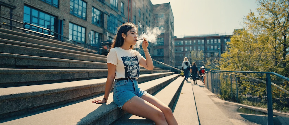 A sunny Atlanta living room with an Oil & Eve delivery bag and cannabis products on a table.